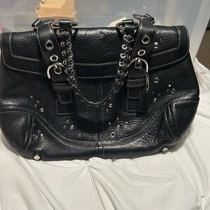 Coach studded satchel in black.